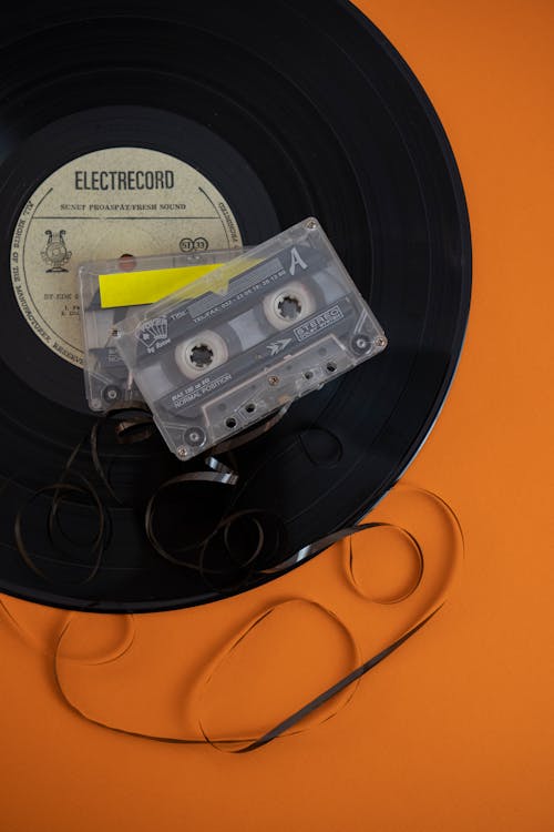 An orange and black record player with a cassette tape