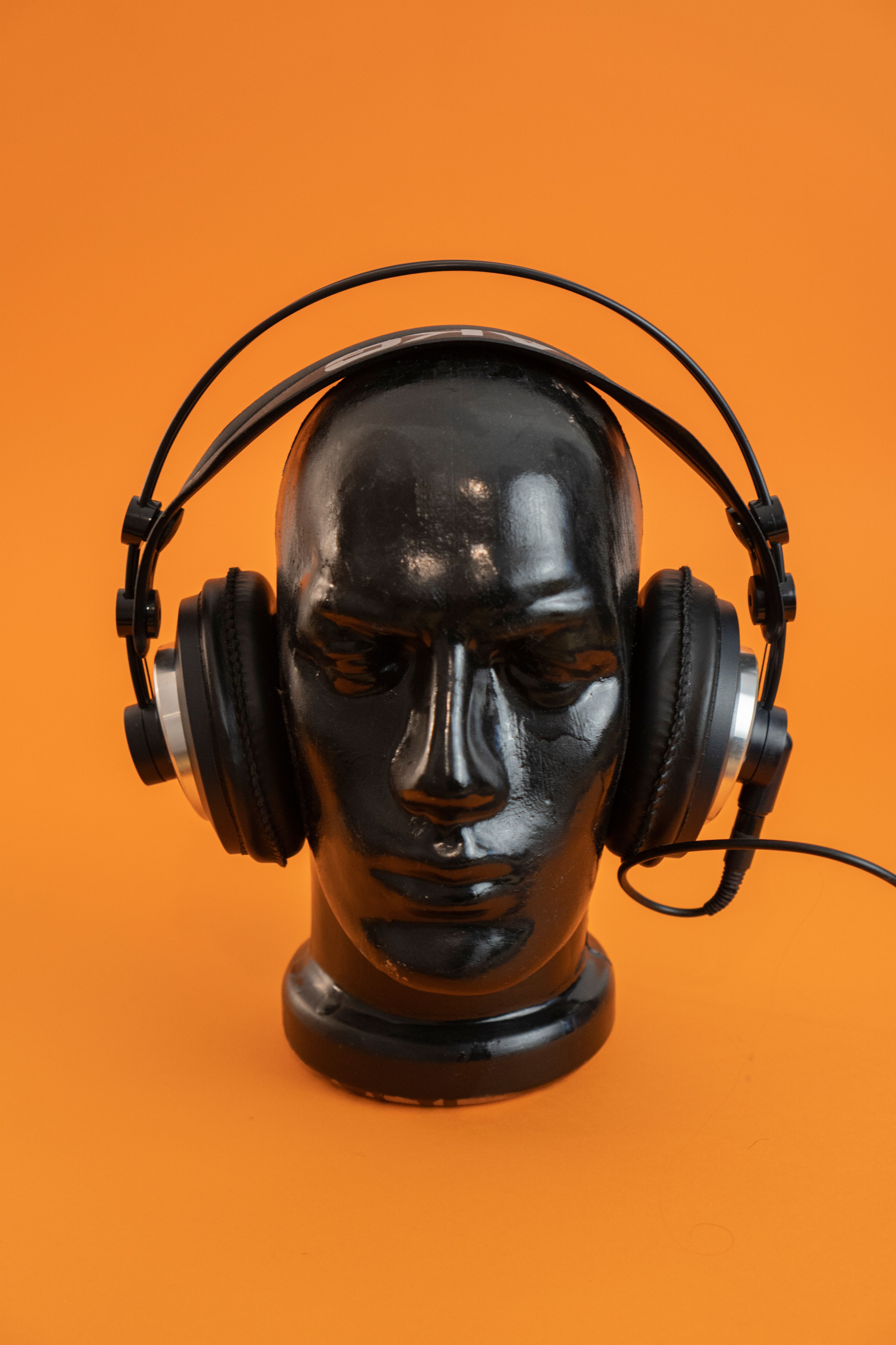 Headphones and audio electronics on orange background with Amazon coupon deals