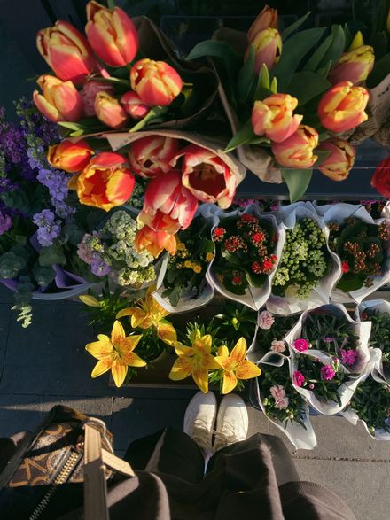 Buckets of cut flowers at a market stall — photo by Omorfogallery on Pexels