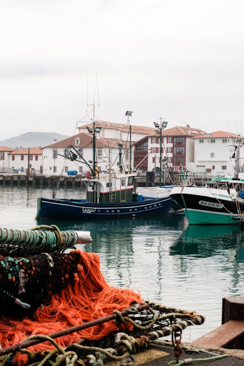 Nets and Fishing Boats on River in Town