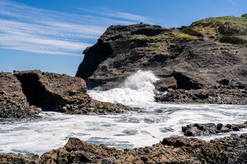 A rocky shoreline with waves crashing into the rocks
