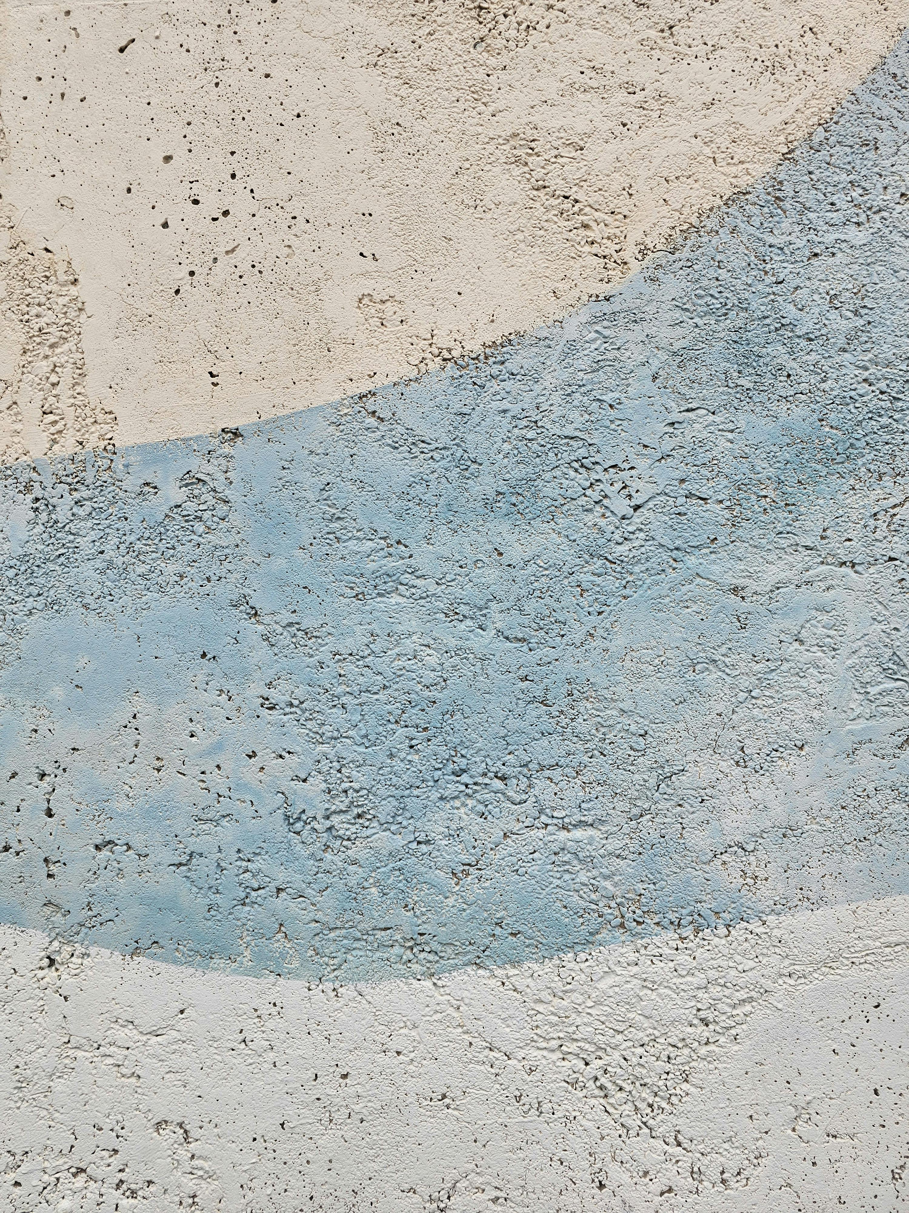 Close-up of a textured wall with blue and white abstract design creating a serene ambiance.