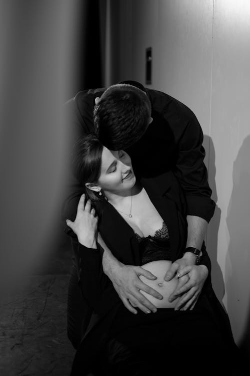A man and woman hugging in a black and white photo