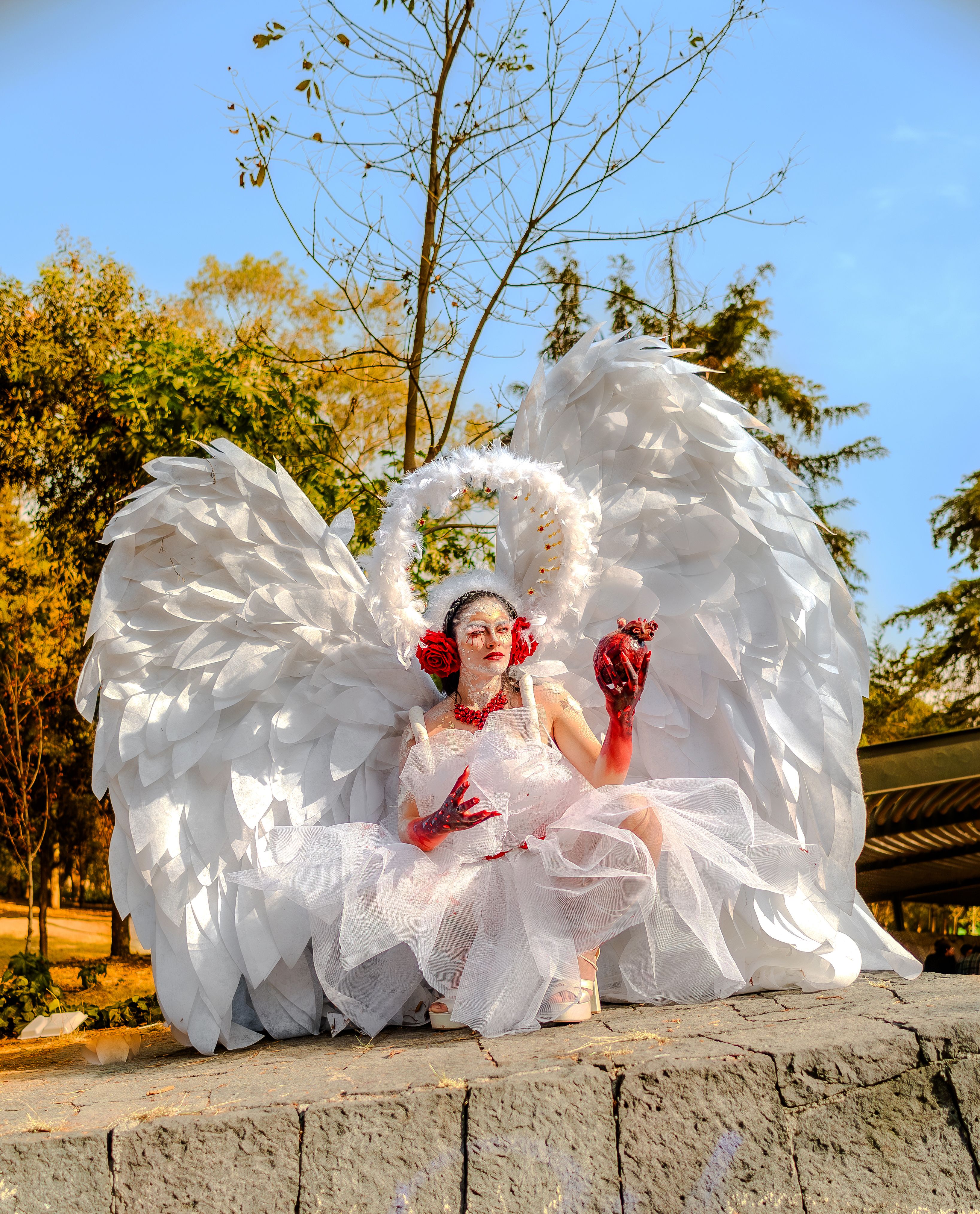 Conceptual photo of woman in angelic costume with wings, photographed outdoors in CDMX.