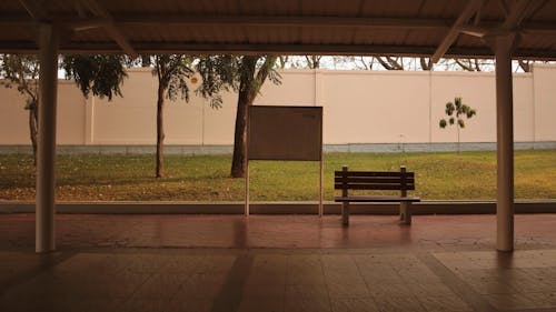 Sign with a City Map Next to a Bench on the Sidewalk