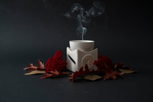A white cup with smoke coming out of it