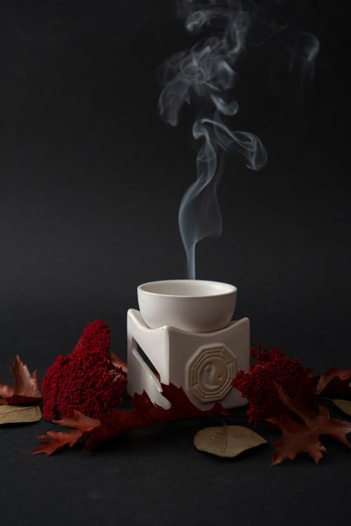 A white cup with smoke coming out of it