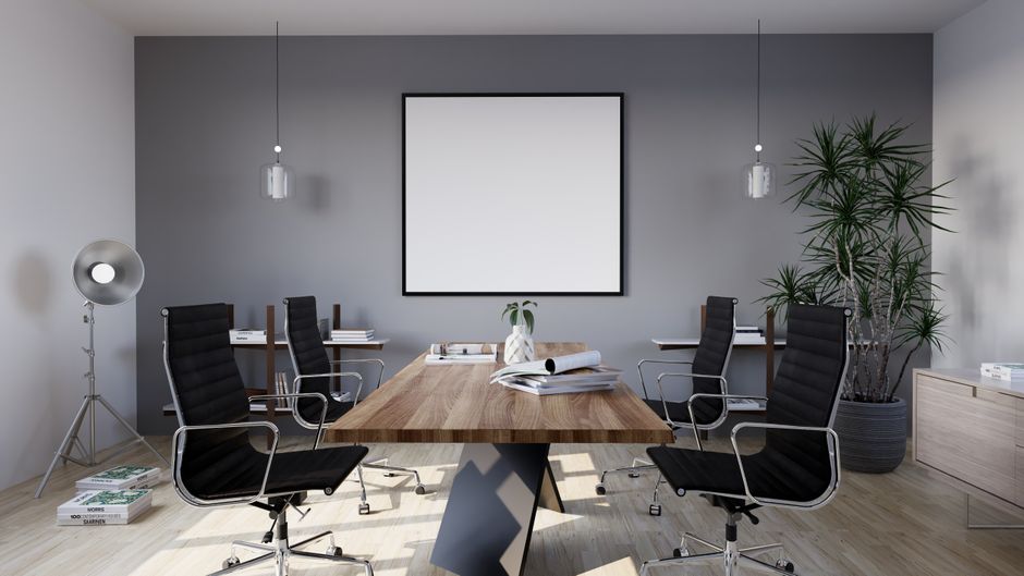 Sleek and modern conference room with minimalist design featuring stylish furniture and indoor plants.