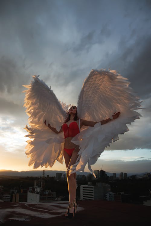A woman in a red bikini with angel wings