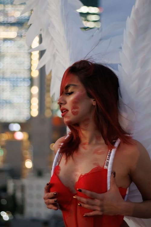 A woman in a red bra and wings