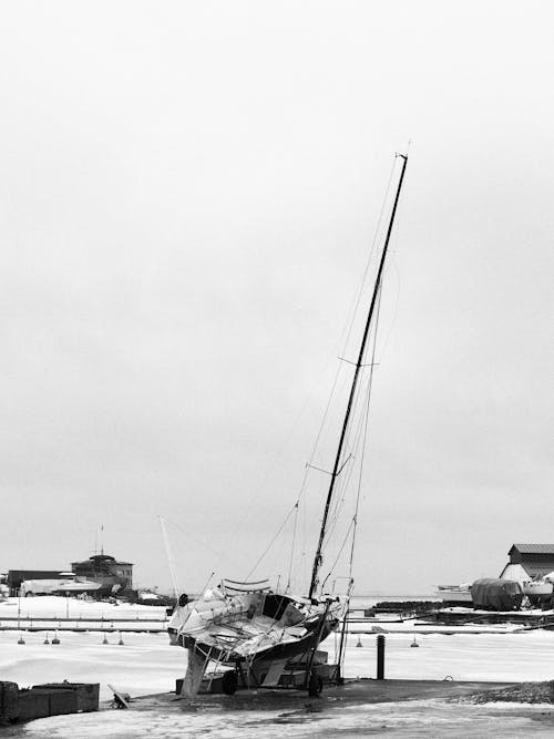 A black and white photo of a boat in the snow