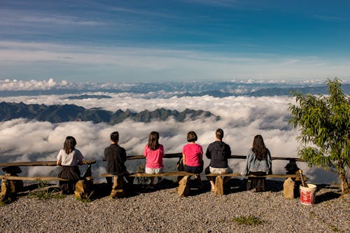 Group of People Sitting by Viewpoint in a Mountain Valley 