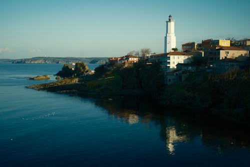 A lighthouse is seen in the distance by the water