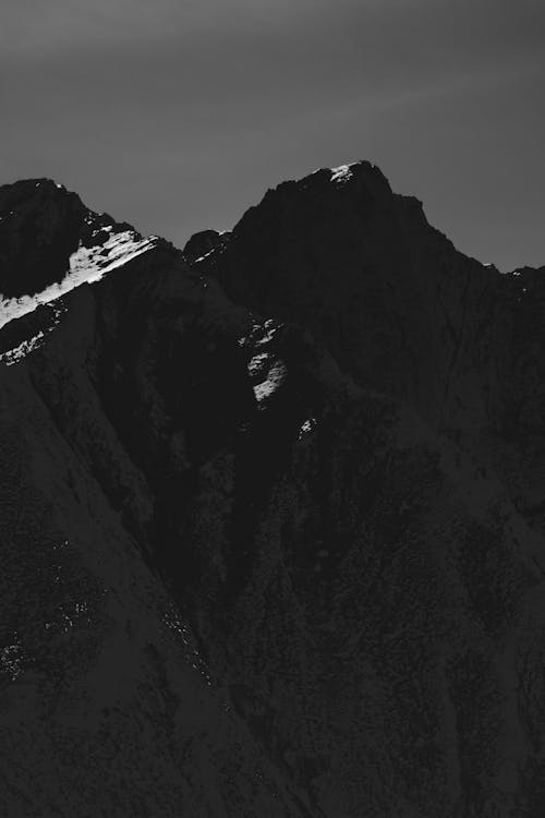 Black and white photograph of mountains with snow