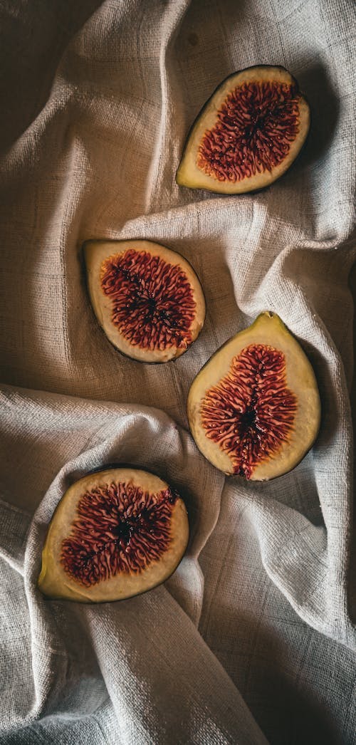 Top View of Figs Cut in Half Lying on a Cloth 