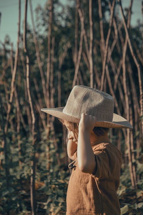 A child wearing a hat in a field