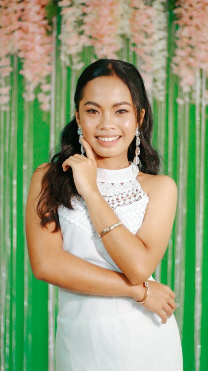 A young woman in white dress posing for a photo