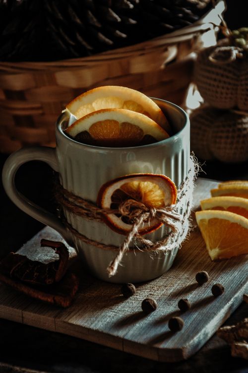 Free Warm winter tea with dried orange slices, cinnamon, and spices. Perfect cozy drink for cold days. Stock Photo