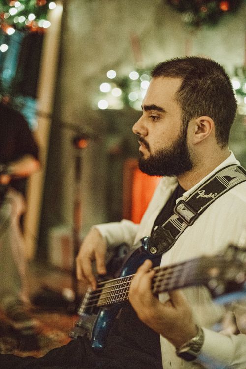Free A bearded musician playing an electric guitar in a cozy indoor setting in Baku, Azerbaijan. Stock Photo