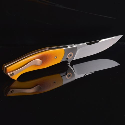 Free A sleek folding knife with a wooden handle displayed against a black background. Stock Photo