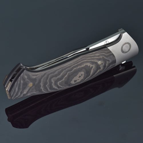 A folding knife with a black and silver handle