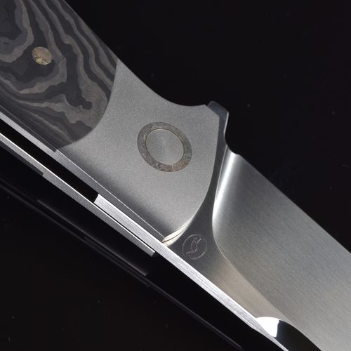Free Detailed close-up of a modern knife blade with textured handle on a black background. Stock Photo