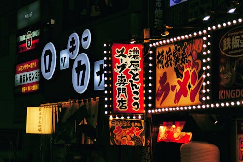 View of Illuminated Neon Signs on a Building in City at Night 