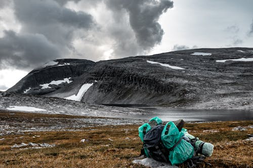 A backpack against the background of a beautiful orange mountain in Norway.
