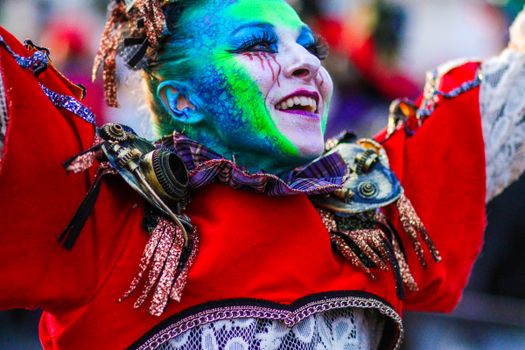 Colorful portrait of a smiling carnival performer in costume at Viareggio, Italy.
