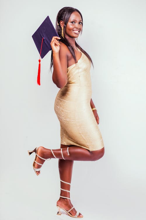 Woman Standing and Holding Academic Hat 