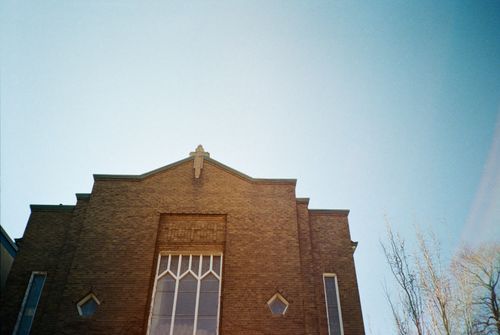 Free A historic church facade in Toronto captured under a clear blue sky, showcasing architectural design. Stock Photo