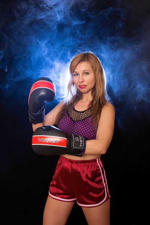 Models In Boxing Poses Female Model Posing in Boxing Gloves · Free Stock Photo