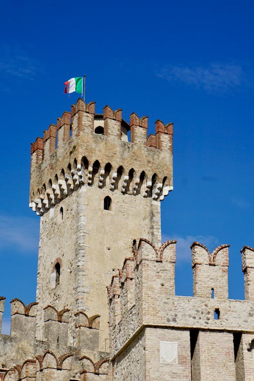 The tower of a castle with an italian flag
