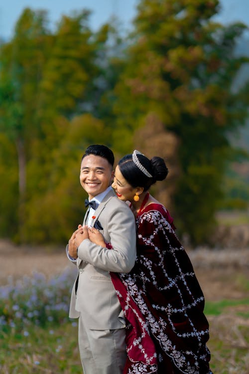 Bride Hugging the Groom and Smiling 