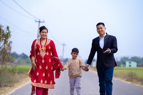 Free Happy Mother and Father Holding Hands with Son Stock Photo