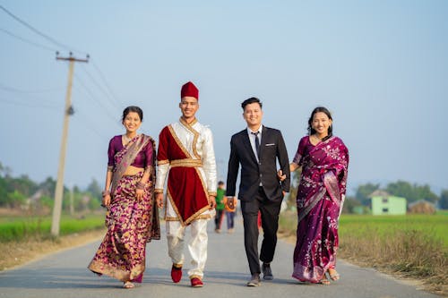 Happy Couples in Traditional Clothing on Road