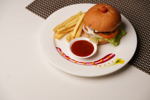 A plate with a burger and fries on it