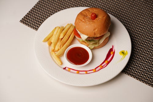 A Burger with Fries and Ketchup on a Plate 