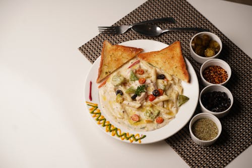 Free A Pasta Dish with Toasted Bread on the Side  Stock Photo