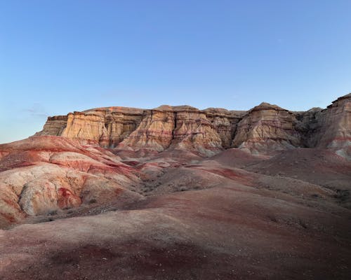 The red and brown rocks are in the desert