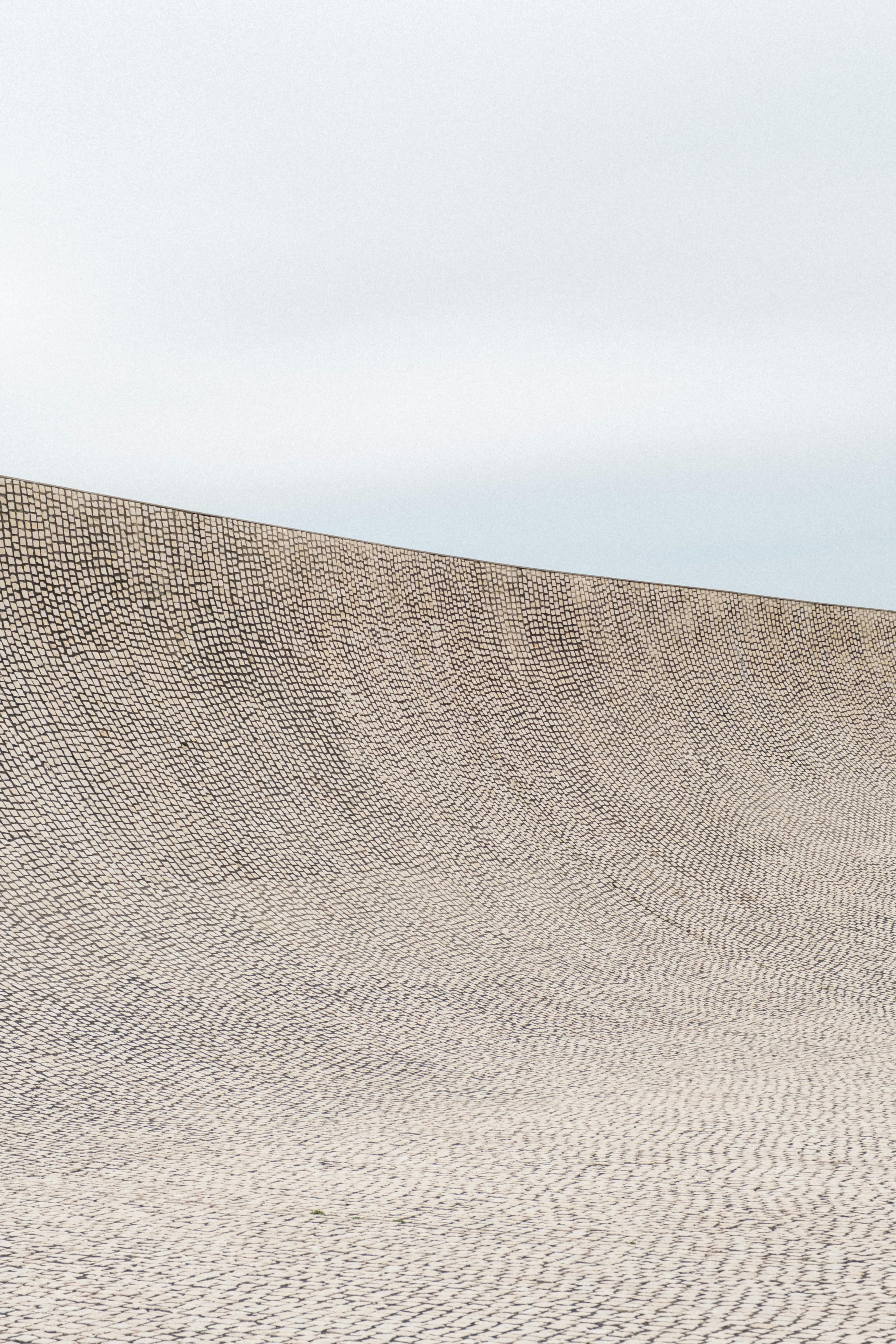 A smooth concrete ramp at an urban skate park in Biarritz, France, under an overcast sky.