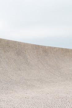 A smooth concrete ramp at an urban skate park in Biarritz, France, under an overcast sky.