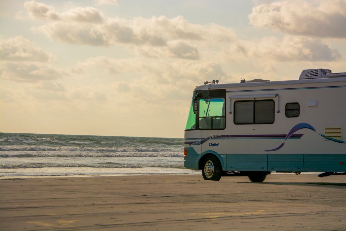 Class A motorhome parked on a beach