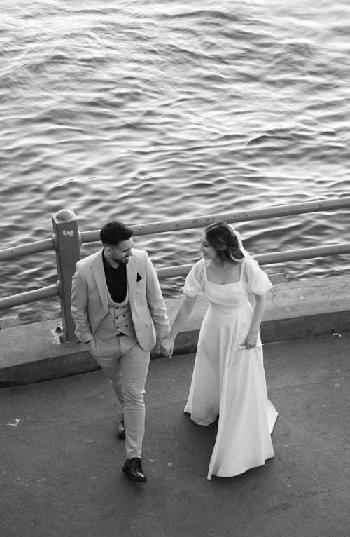 Newlyweds Holding Hands and Walking Together