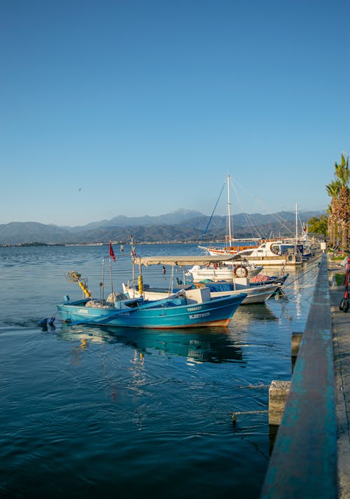 A boat is docked at a pier near the water