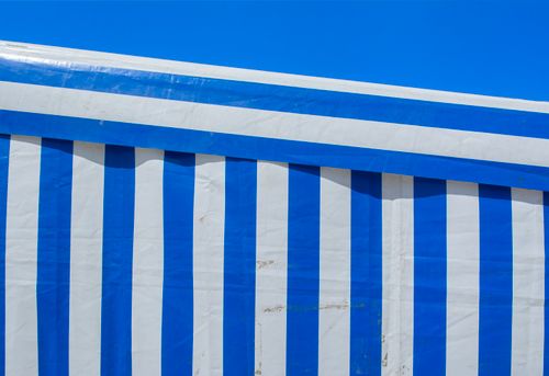 Free Close-up of blue and white striped canvas with vivid colors under clear blue sky. Stock Photo