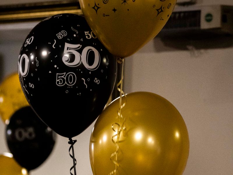 Black and gold balloons with number foils