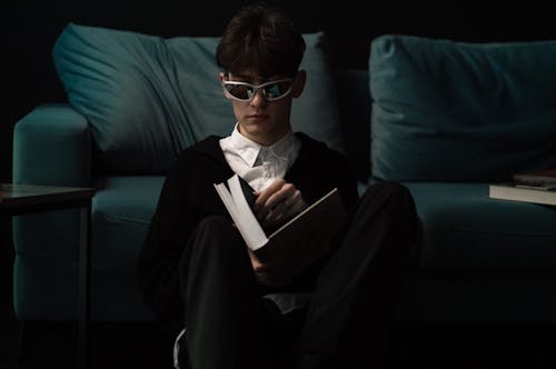 Man in Sunglasses Reading Book