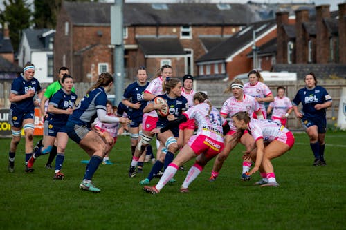 A group of women playing rugby on a field
