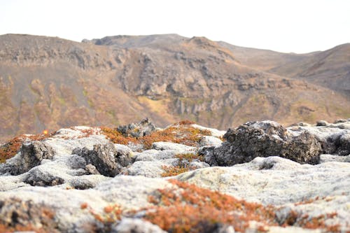 Snow on Rocks with Hills behind